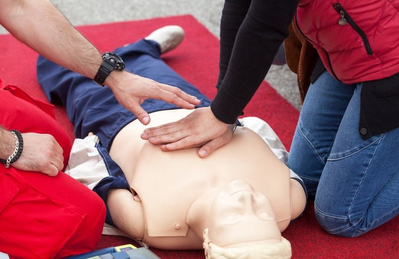 Two people learning first aid and CPR