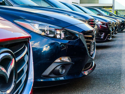 Close-up of a row of parked fleet vehicles