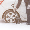 Person using snow shovel to dig out their car
