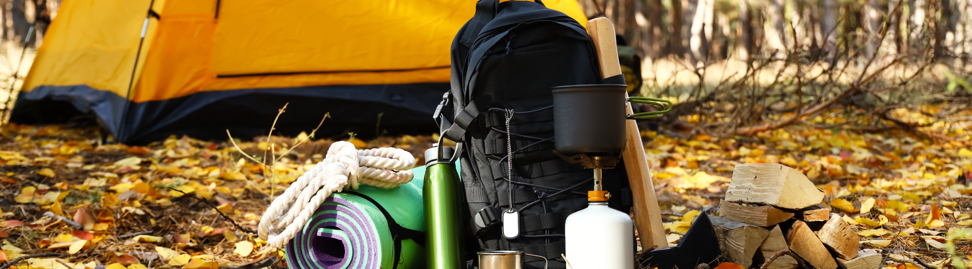 Survival kit essentials laid out including food, water, tools, and emergency supplies