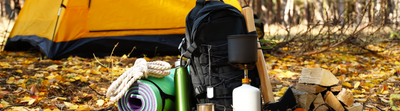 Survival kit essentials laid out including food, water, tools, and emergency supplies
