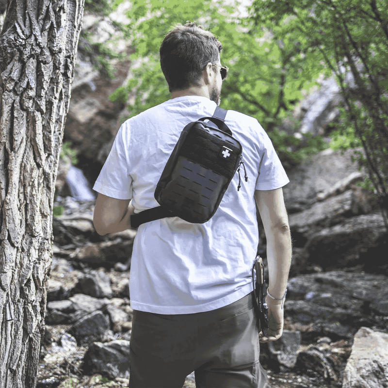 Man wearing MyFAK Pro First Aid Kit on a hike