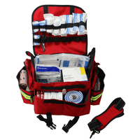 Red first responder trauma kit with various supplies on a white background.