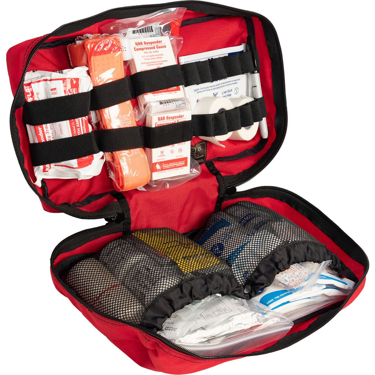 Trauma first aid kit open in a red case with compressed gauze option.