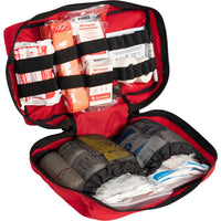 Trauma first aid kit open in a red case with compressed gauze option.